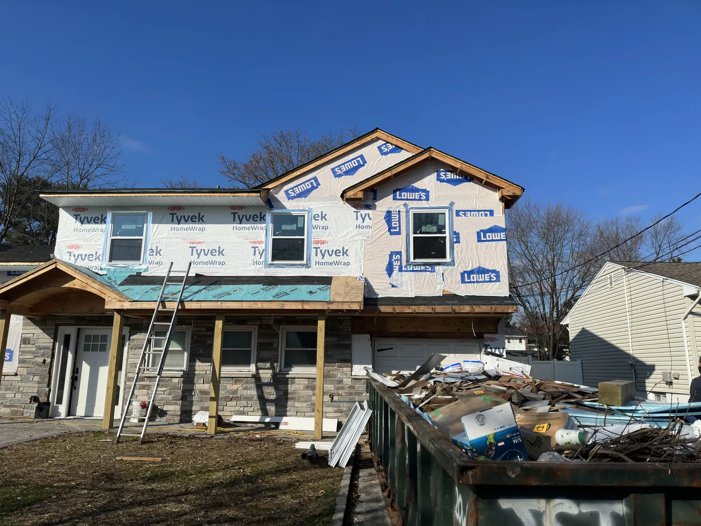 Open framing wrapped in weather-tight Tyvek shell — after