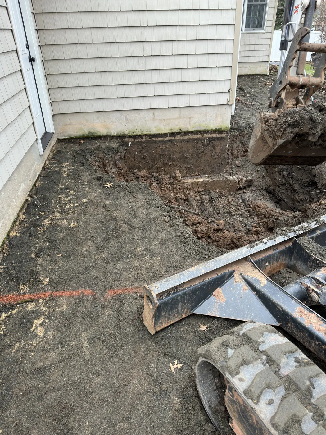 Foundation excavation transformed into framed two-story addition — before